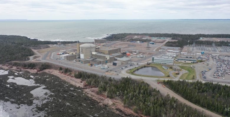 A picture taken from the air of a nuclear power plant on the edge of the land next to the Bay of Fundy.