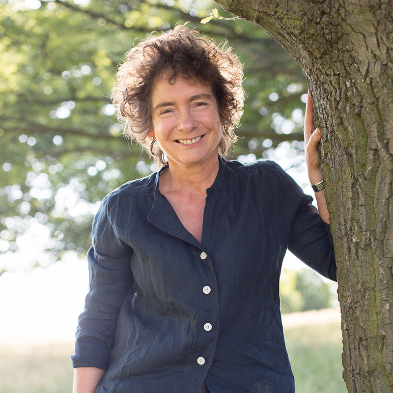 A woman facing the camera and smiling widely