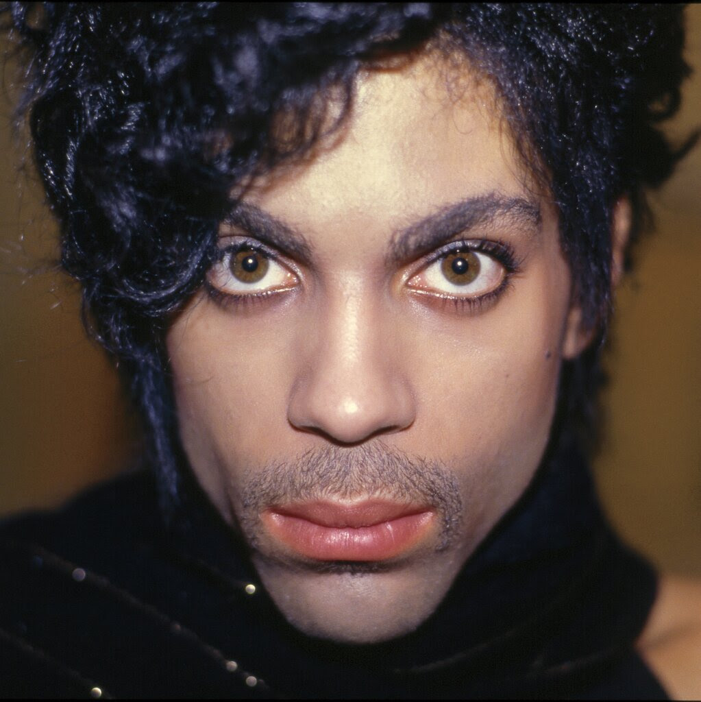 A close-up portrait of Prince’s face.