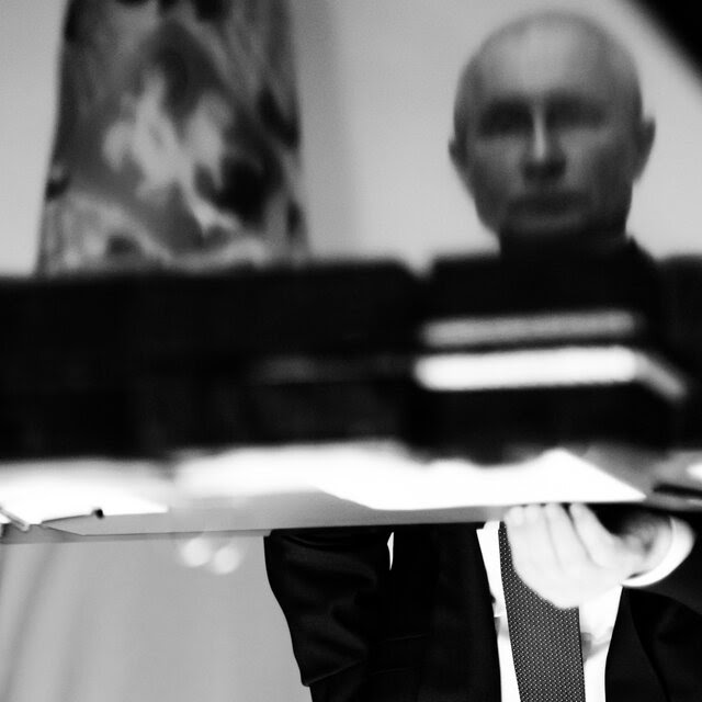 A black-and-white image of Vladimir Putin, split in two.