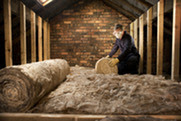 Person installing loft insulation 