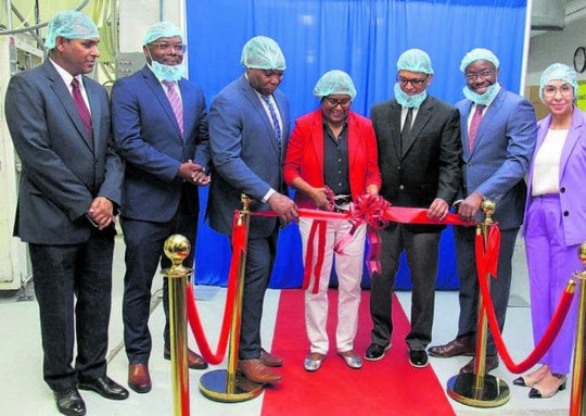 Minister of Trade and Industry Paula Gopee-Scoon cuts the ribbon to commission two new packaging lines at the National Flour Mill, Port-of- Spain yesterday. Others in photo from left are permanent secretary in the Ministry of Trade and Industry Randall Karim, Trinidad and Tobago Manufacturers Association chairman Roger Roach, Minister in the Ministry of National Security Keith Scotland, SC, chairman of NFM Ashmeer Mohamed, CEO Ian Mitchell and director Sonja Voisin. PHOTO BY VASHTI SINGH