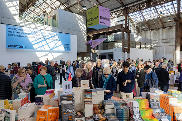 The Gleebooks shop at Carriageworks at the 2024 Festival with people browsing and buying books