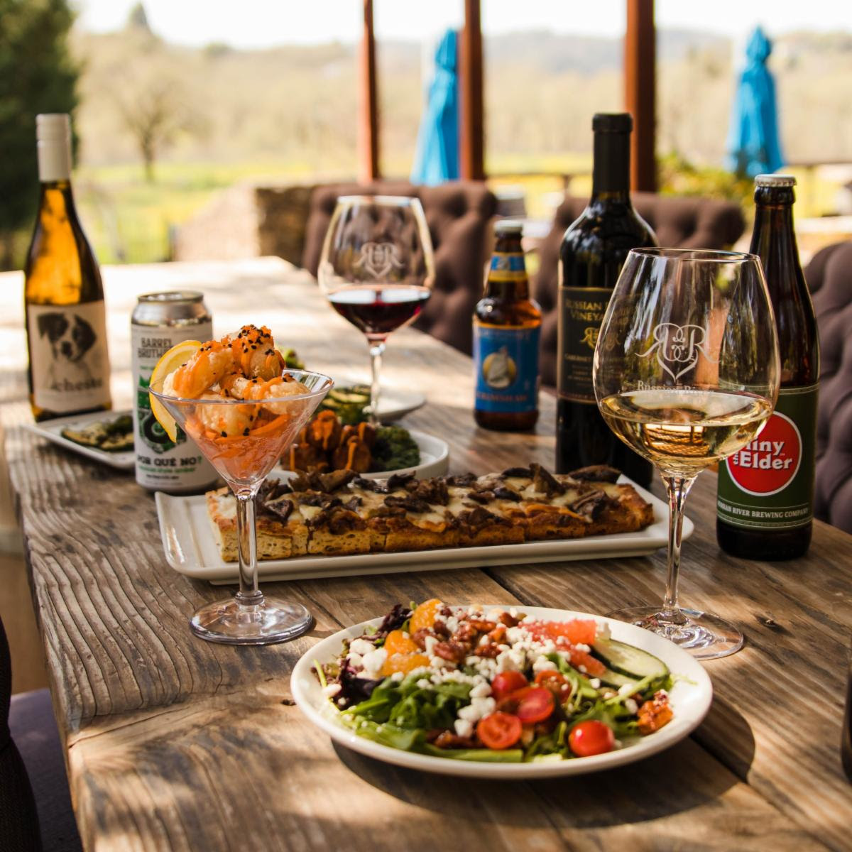 table with wine, beer, and food