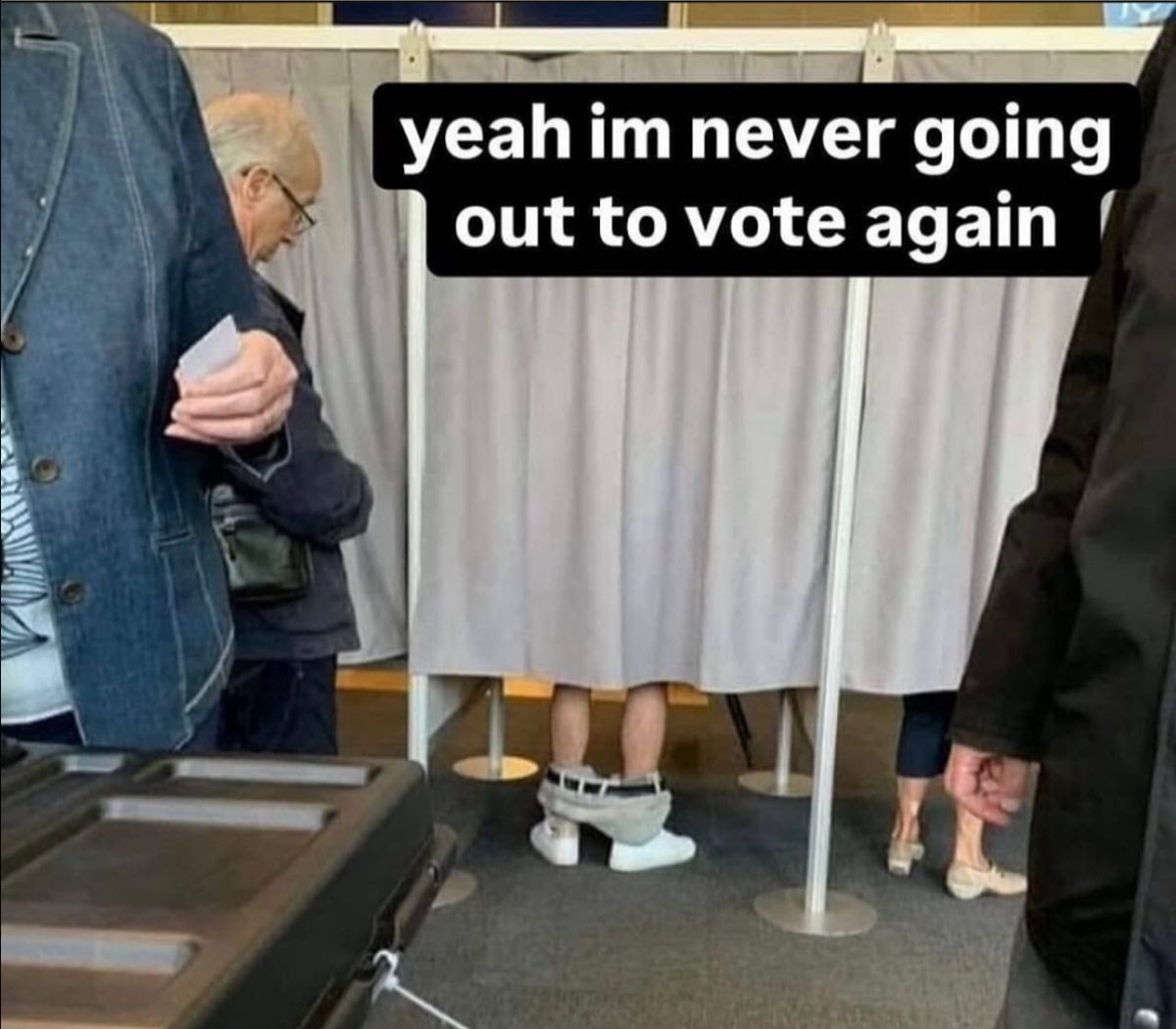 Man in votin booth with pants down.