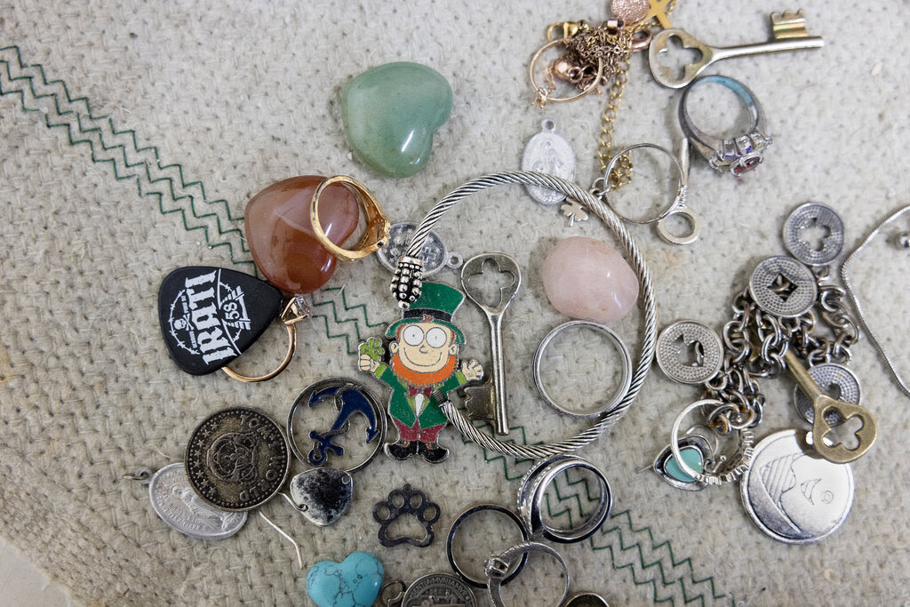 A group of objects found in the fountain, including key rings and pieces of jewelry.