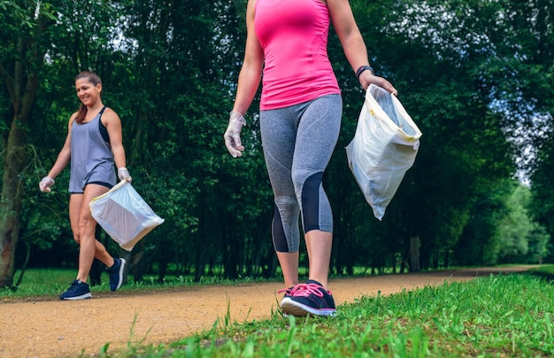 Girls with garbage bag doing plogging