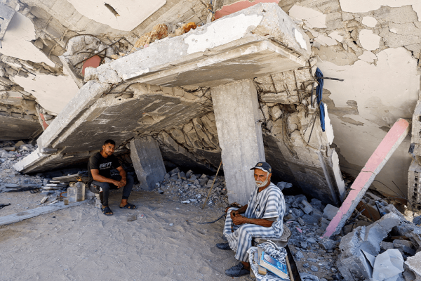 Palestinians rest under the rubble of their destroyed house