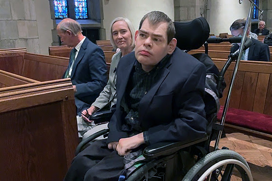 Powell Richardson and his family sit in a special row in the sanctuary of Church Street United Methodist in Knoxville, Tennessee. Church Street recently added designated spaces to better accommodate persons in wheelchairs. Photo from video by Lilla Marigza, UM News.