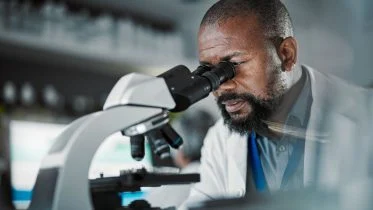 Scientist Using Microscope