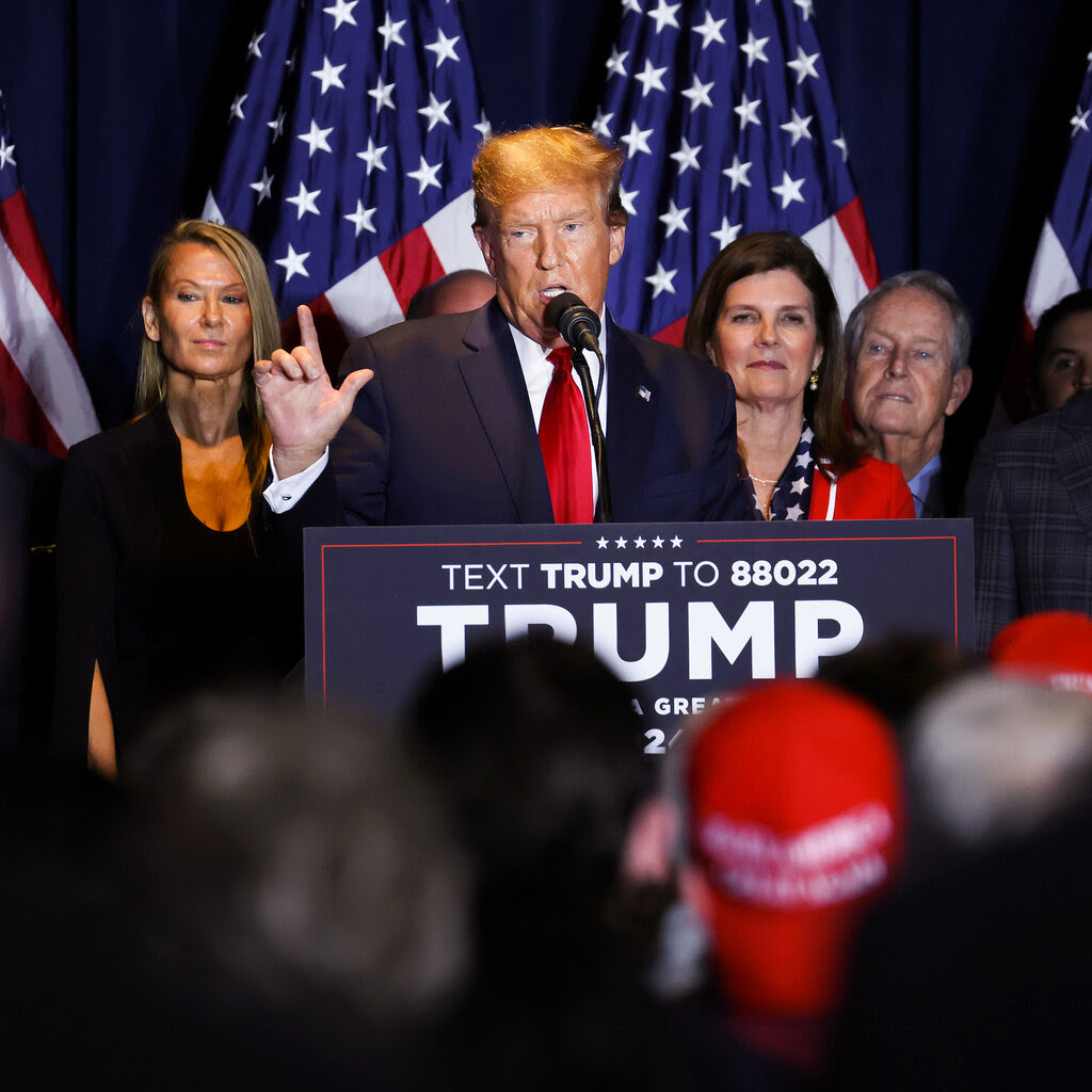 Donald Trump gives a speech at a podium.  