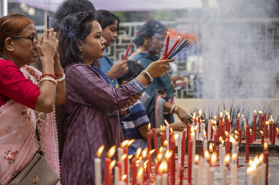 Hindu devotees pray at a temple.