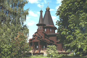 A church is seen between two trees.