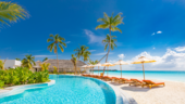 Beautiful sunny pool beside a beach resort.