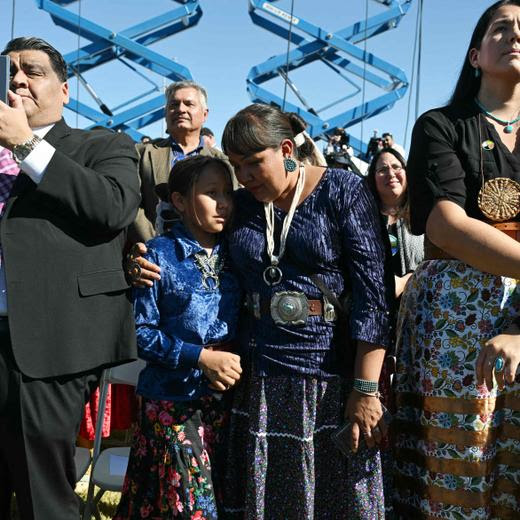 People listen as they wait for US President Joe Biden to speak at the Gila River Crossing School in the Gila River Indian Community, in Laveen Village, near Phoenix, Arizona on October 25, 2024. (Photo by ANDREW CABALLERO-REYNOLDS / AFP)