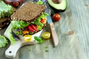 Vegan rye sandwich with fresh avocado, salad,veggies, healthy snack, vitamin and diet food copy space