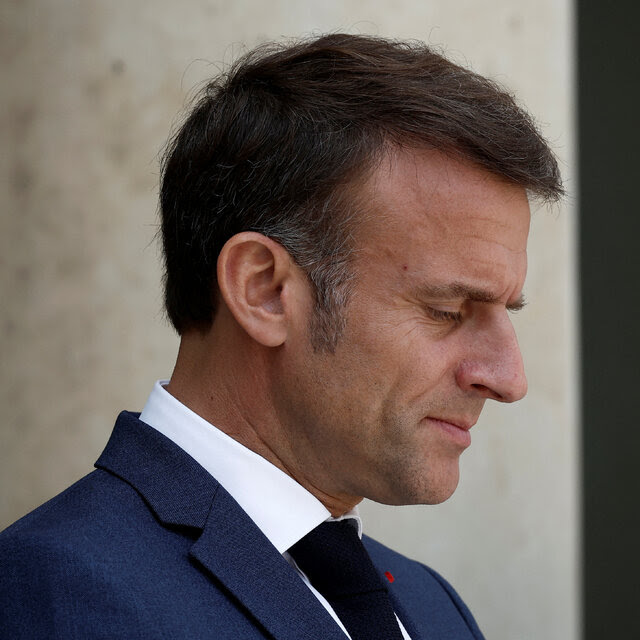 A portrait of President Emmanuel Macron of France in profile.