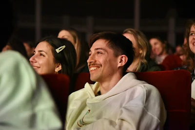 Audiencia disfrutando de un evento cultural en un teatro - ideal para destacar funciones de cine y teatro, exposiciones, talleres, paseos de compras y encuentros corales