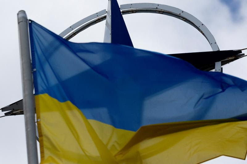 A Ukrainian flag alongside the NATO emblem, Kyiv, July 2023