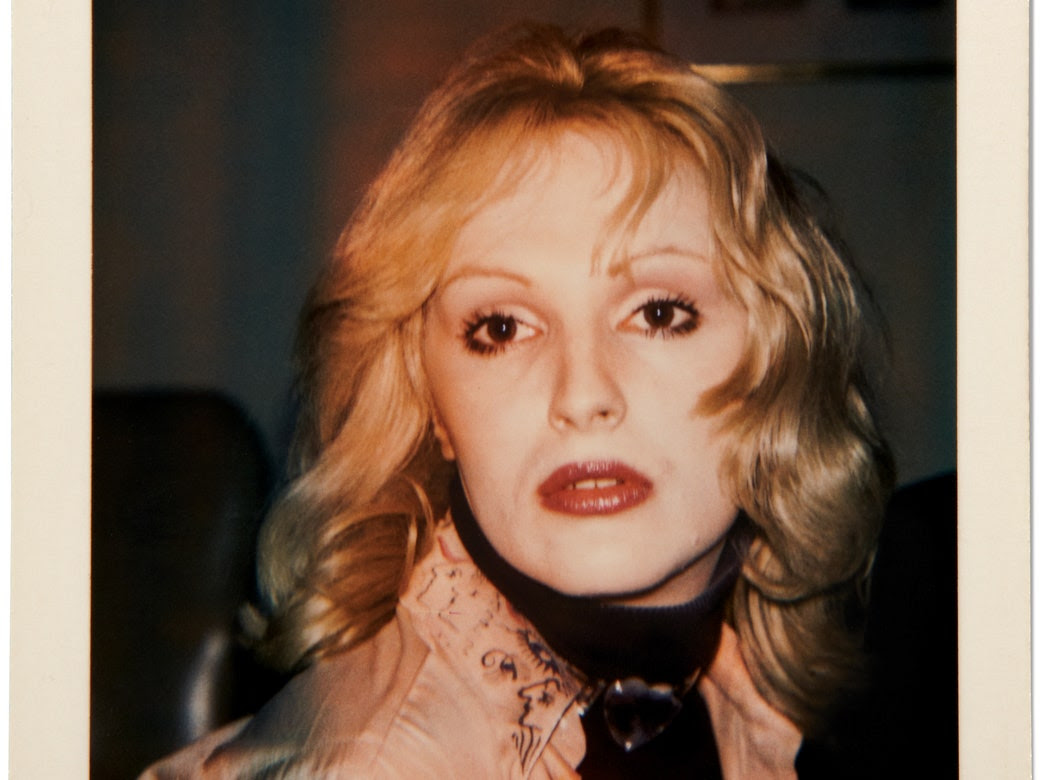 A closeup portrait of Candy Darling, photographed by Andy Warhol.