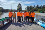 Connor Robison’s GulfCorps crew poses together wearing orange high-visibility shirts as they prepare for work