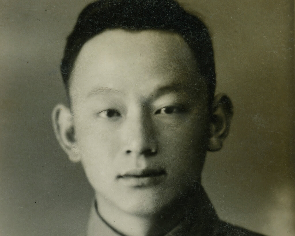 A young man in a sepia-toned photograph wearing a Chinese military uniform.