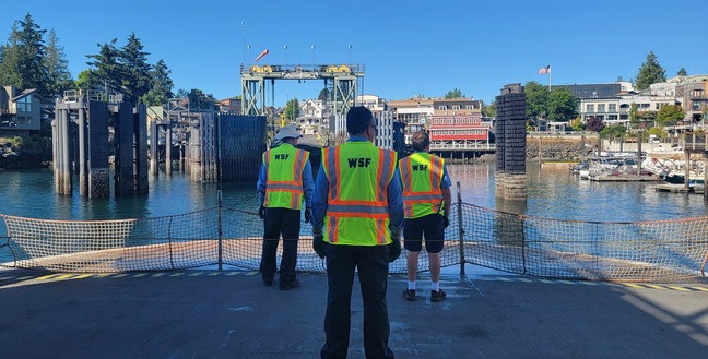 Three ferry crew members on the car deck as the vessel approaches Friday Harbor terminal