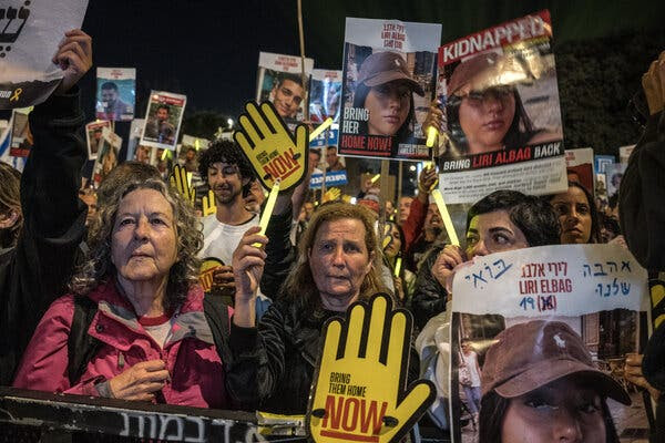 A crowd of people, some holding signs, called for hostages to be freed.