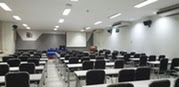 lecture hall with multiple empty tables and seats