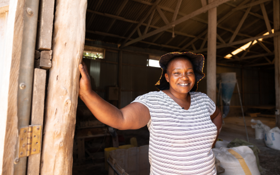 Peace Alinda checks the quality of the flour made for her at a local miller in her village in Gayaza, Uganda.