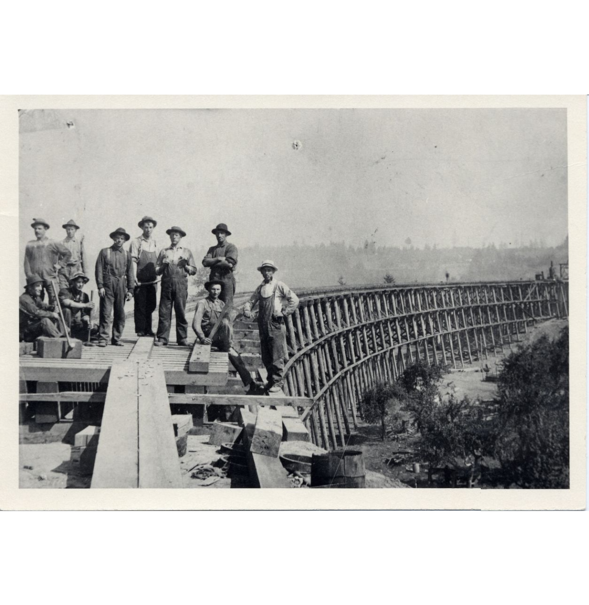 Circa 1910 photograph of ten men on a half-built railroad bridge in Oswego