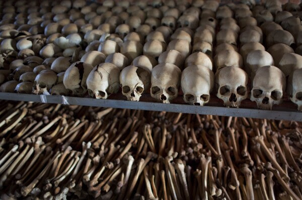 FILE - The skulls and bones of some of those who were slaughtered as they sought refuge inside the church are laid out as a memorial to the thousands who were killed in and around the Catholic church during the 1994 genocide in Ntarama, April 4, 2014. The Rwanda Tribunal convicted a string of leaders involved in the African nation's 1994 genocide when some 800,000 people, mainly ethnic Tutsis, were slaughtered. (AP Photo/Ben Curtis, File)