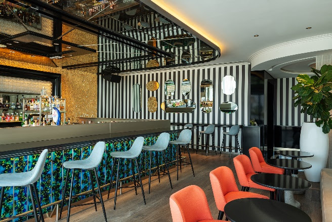 A bar with chairs and tablesDescription automatically generated