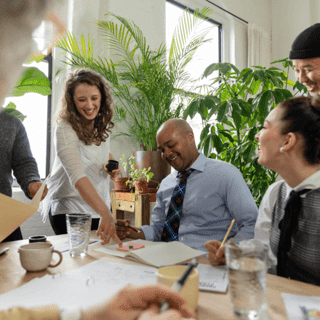 Coworkers happily sitting at a table