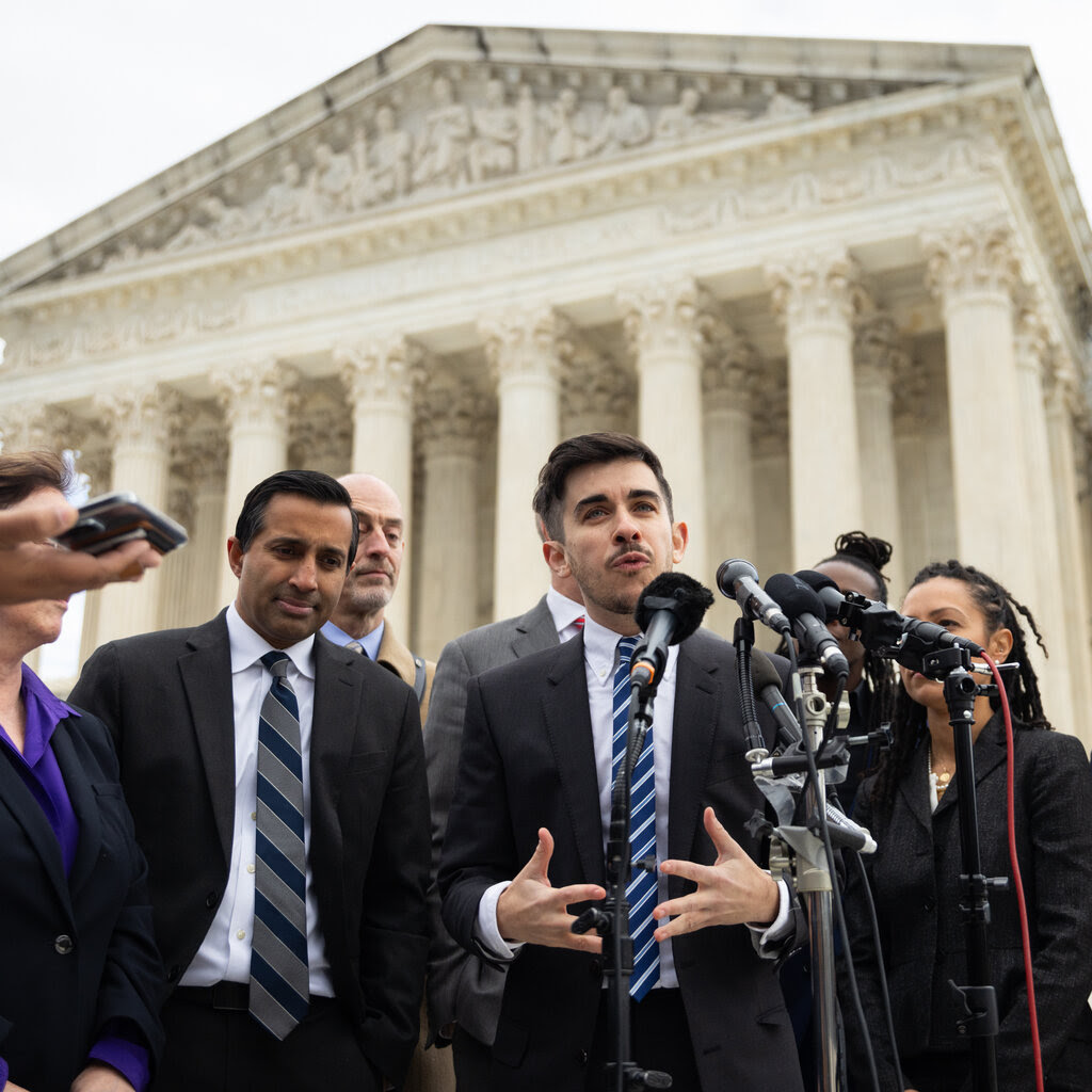 A lawyer speaking outside the Supreme Court building.