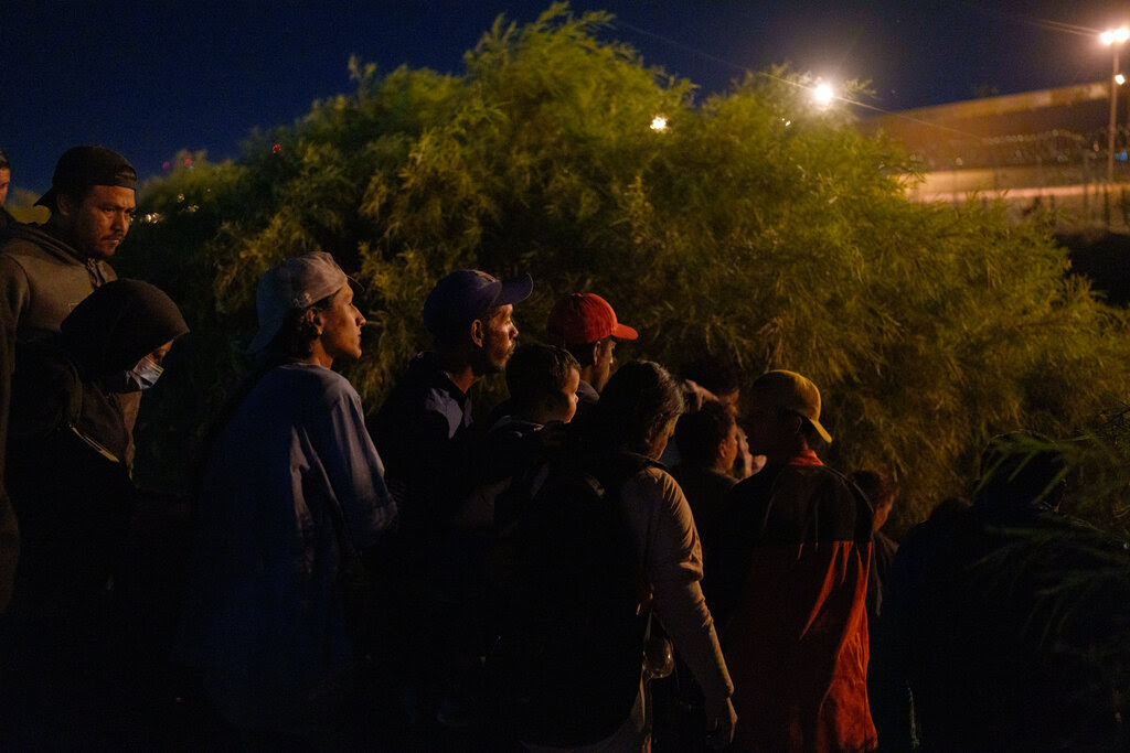 Migrants in the bushes near the border.