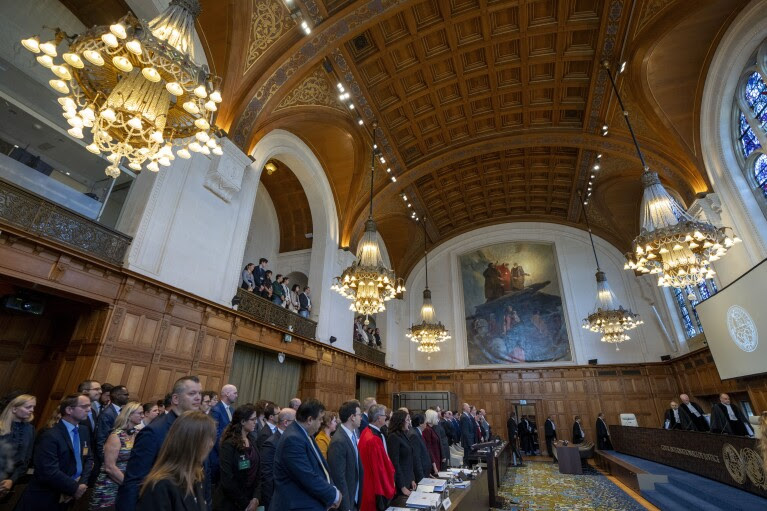 All rise as judges, rear, enter the World Court where Ukraine's legal battle against Russia over allegations of genocide used by Moscow to justify its 2022 invasion, resumed in The Hague, Netherlands, Monday, Sept. 18, 2023.  (AP Photo/Peter Dejong, File)