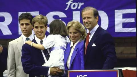 Getty Images Hunter (extreme left) looks on with his family after Joe Biden announces his first run for the presidency in 1988