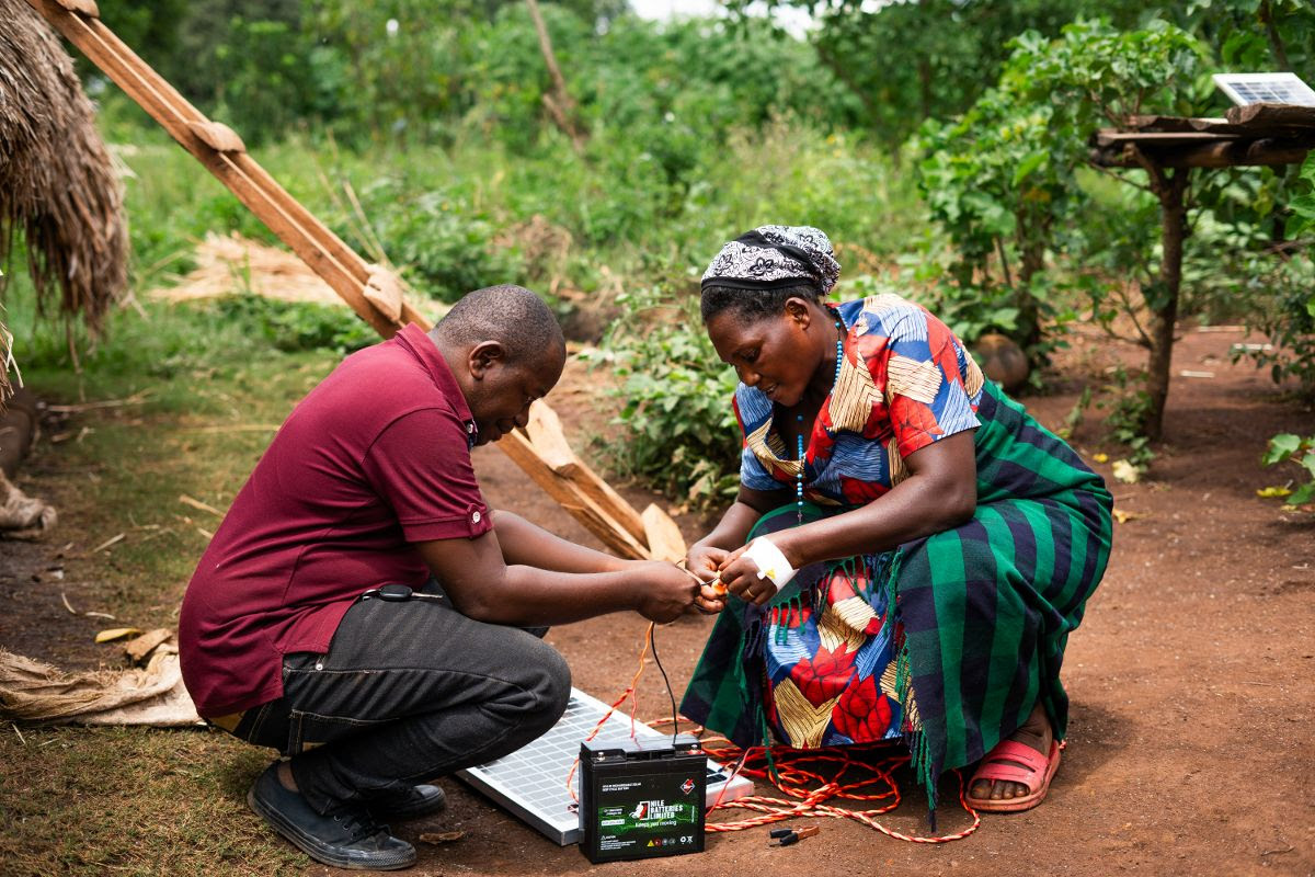 Image depicts member of the local community in Uganda training to build, connect and maintain solar panels