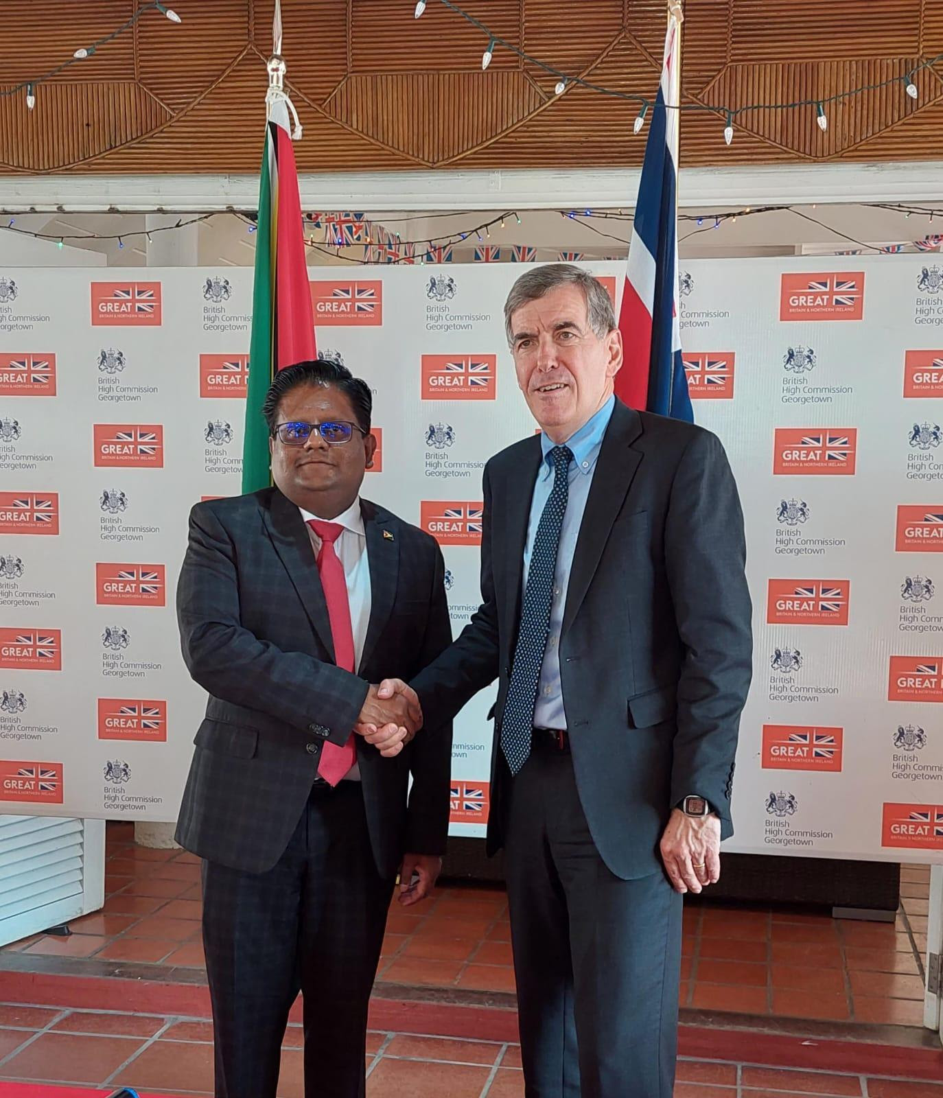 Senior Minister in the Office of the President, with responsibility for Finance, Dr. Ashni Singh shares a handshake with UK Minster, David Rutley, Parliamentary Under-Secretary of State at the Foreign, Commonwealth & Development Office