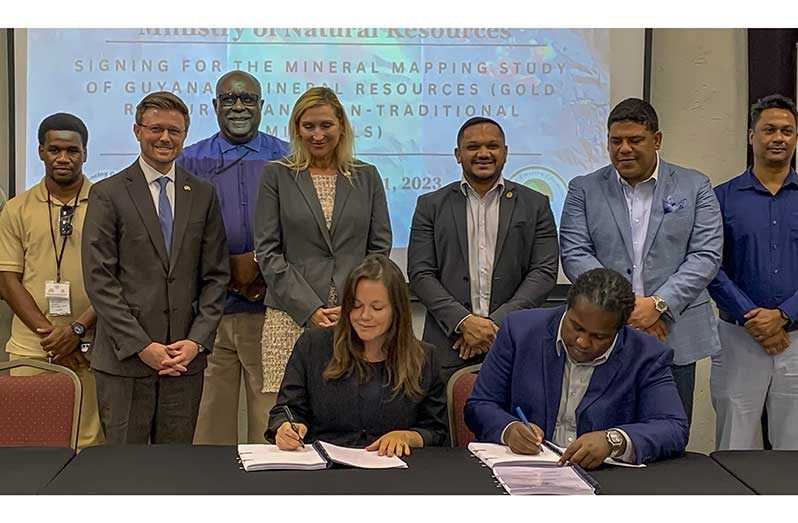 CEO of Global Ventures Consultancy Inc, Emily King and Permanent Secretary of the Ministry, Joslyn McKenzie sign the MoU ’ ( - ), while flanked by Minister of Natural Resources, Vickram Bharrat; United States Ambassador to Guyana, Nicole Theriot, Guyana Geology and Mines officials and other representatives (Japheth Savory photo)