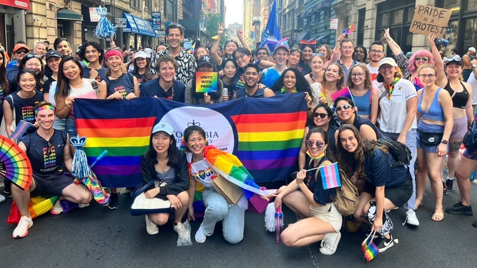 Columbians pose in front of the Columbia Pride banner at the NYC Pride March