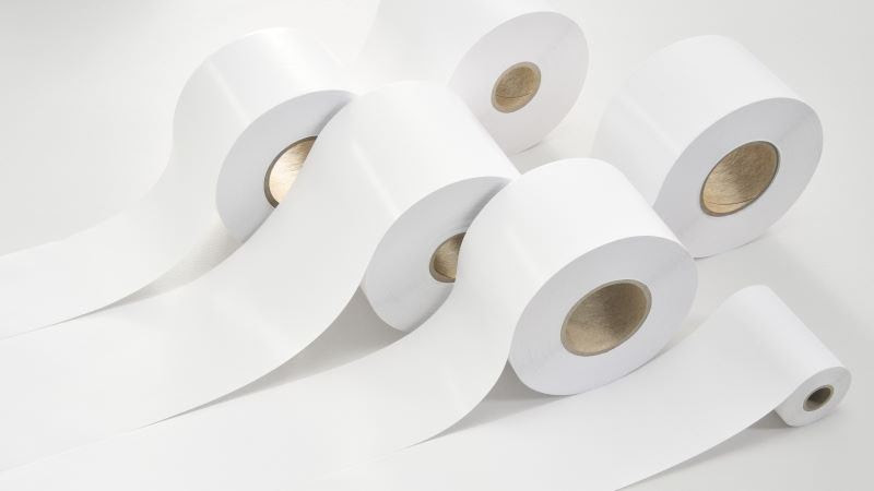 Rolls of white paper on a white surface

Description automatically generated