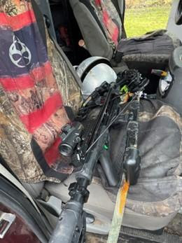 Crossbow sitting on a seat in a vehicle