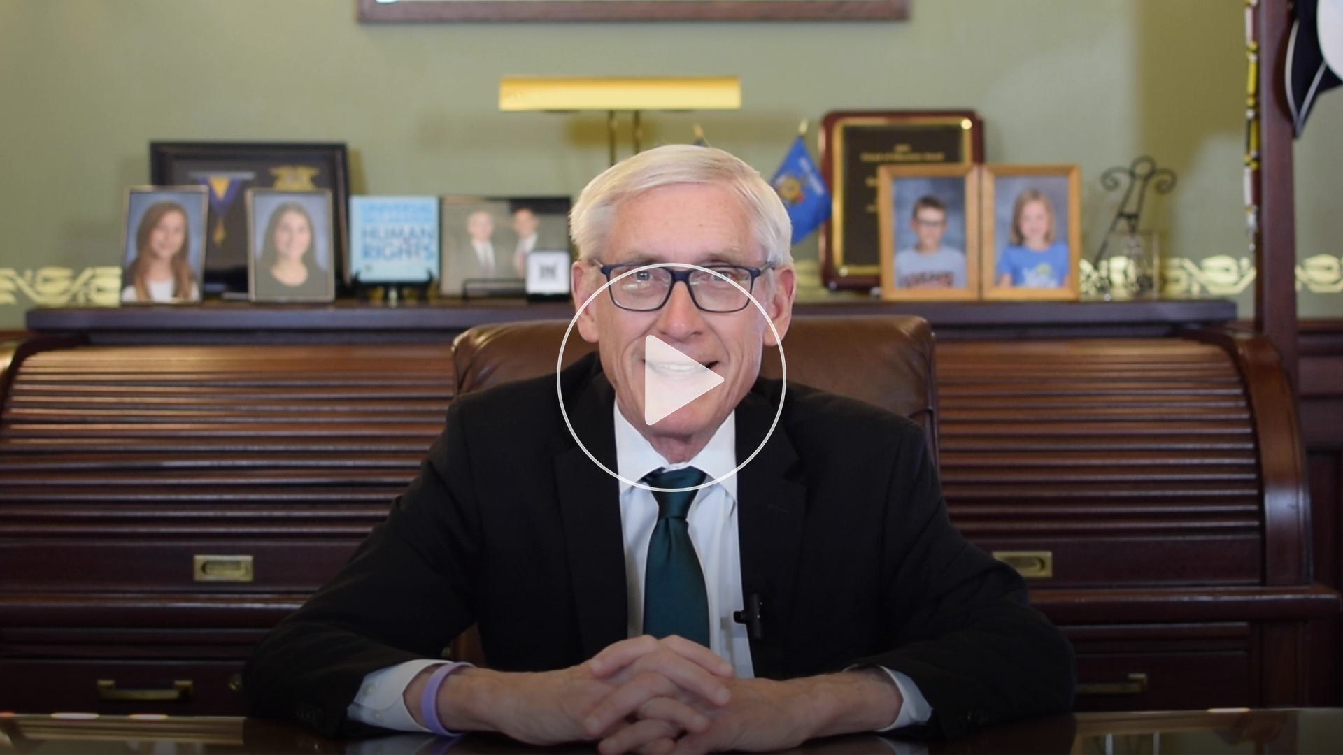 Photo of Governor Evers with a Play Button for a video