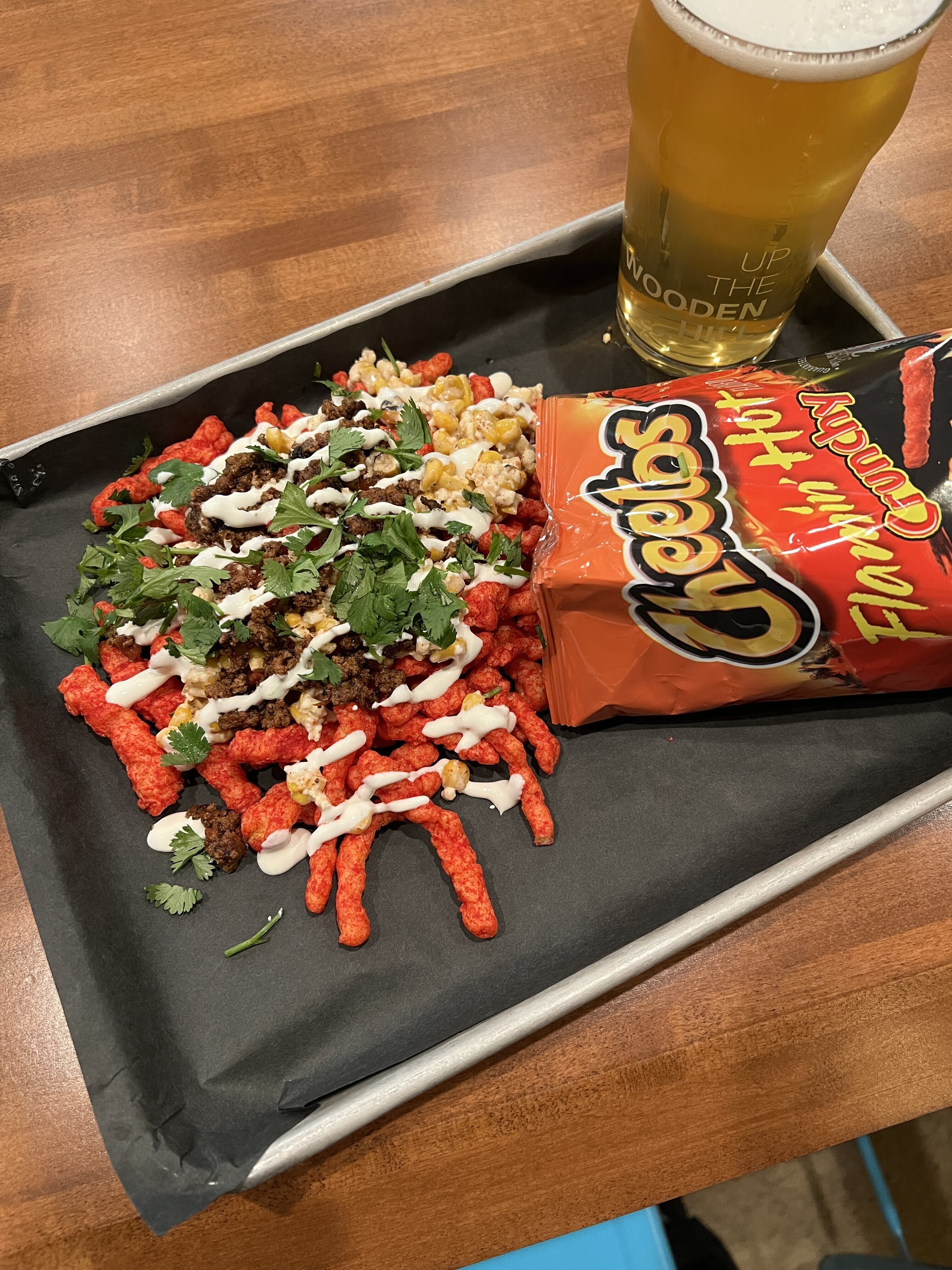 Image of "flamin' hot walking tacos" with a pint of beer