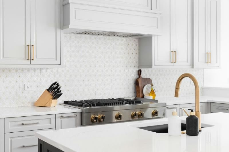 A kitchen with white cabinets and a stove

Description automatically generated