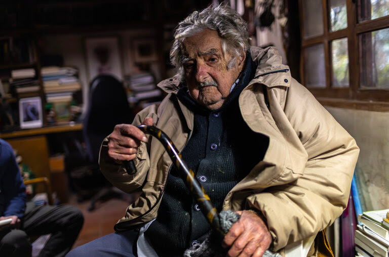 José “Pepe” Mujica sitting and holding his cane. 