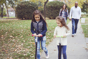 Family walking and scooting