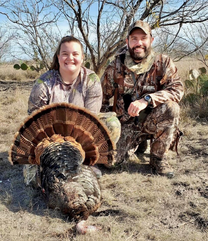 Woman hunter and male hunter with gobbler